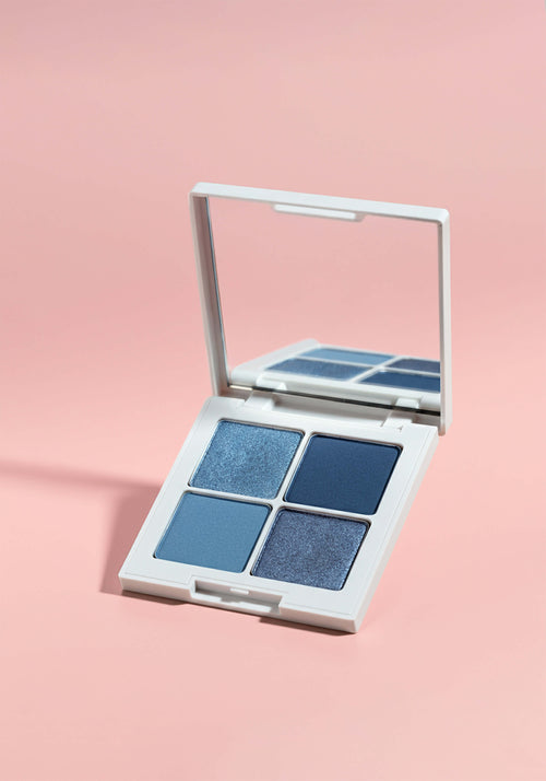 Load image 1 in gallery view. An eyeshadow quad with four shades of blue in square pans in a square compact with a mirror.