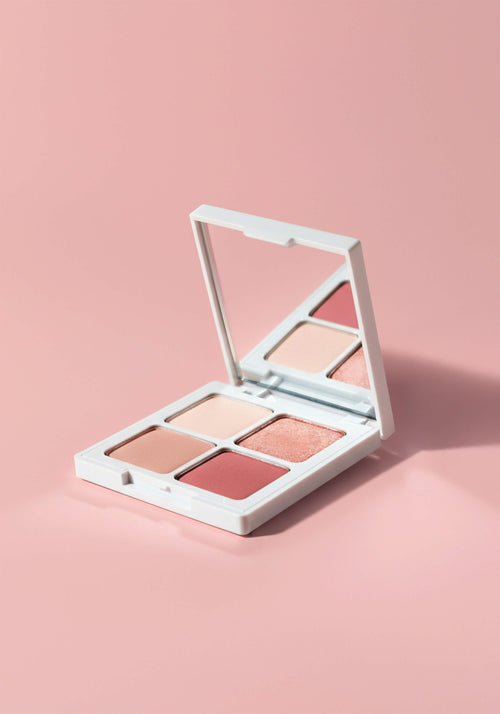 Load image 1 in gallery view. An eyeshadow quad with four rosey pink shades in square pans in a square compact with a mirror.