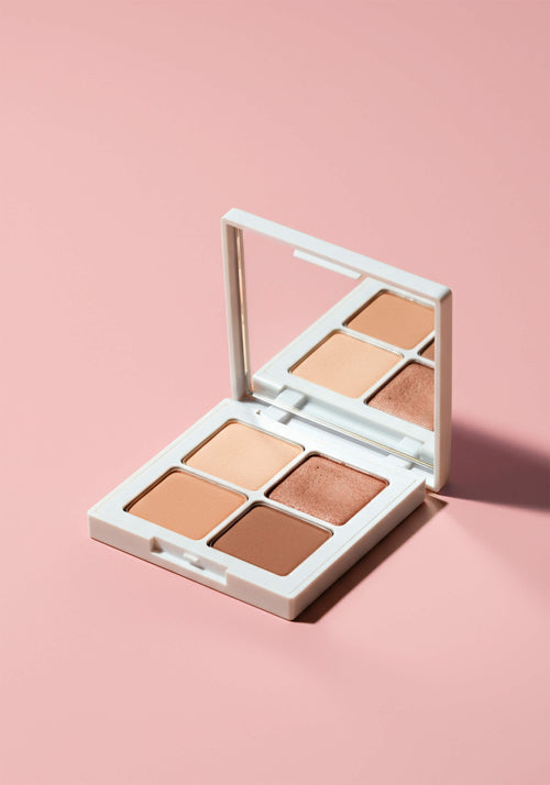 Load image 1 in gallery view. An eyeshadow quad with four brown nude shades in square pans in a square compact with a mirror.