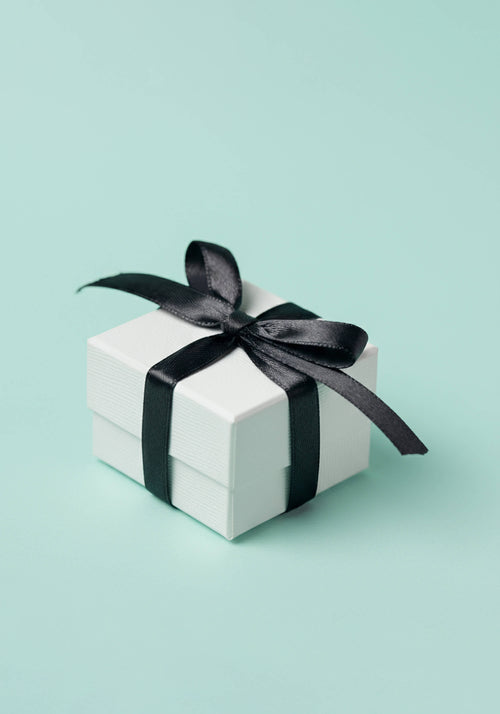 Load image 1 in gallery view. A white gift-wrapped box tied with a black ribbon.