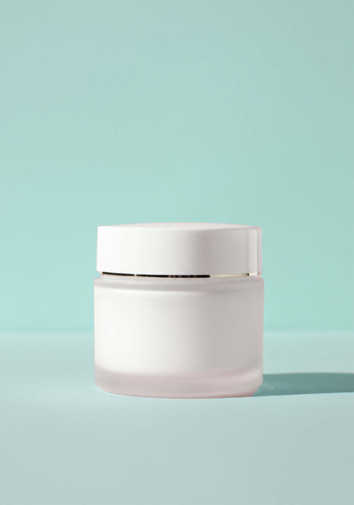 Load image 1 in gallery view. A thick cream moisturizer in frosted glass jar packaging. 