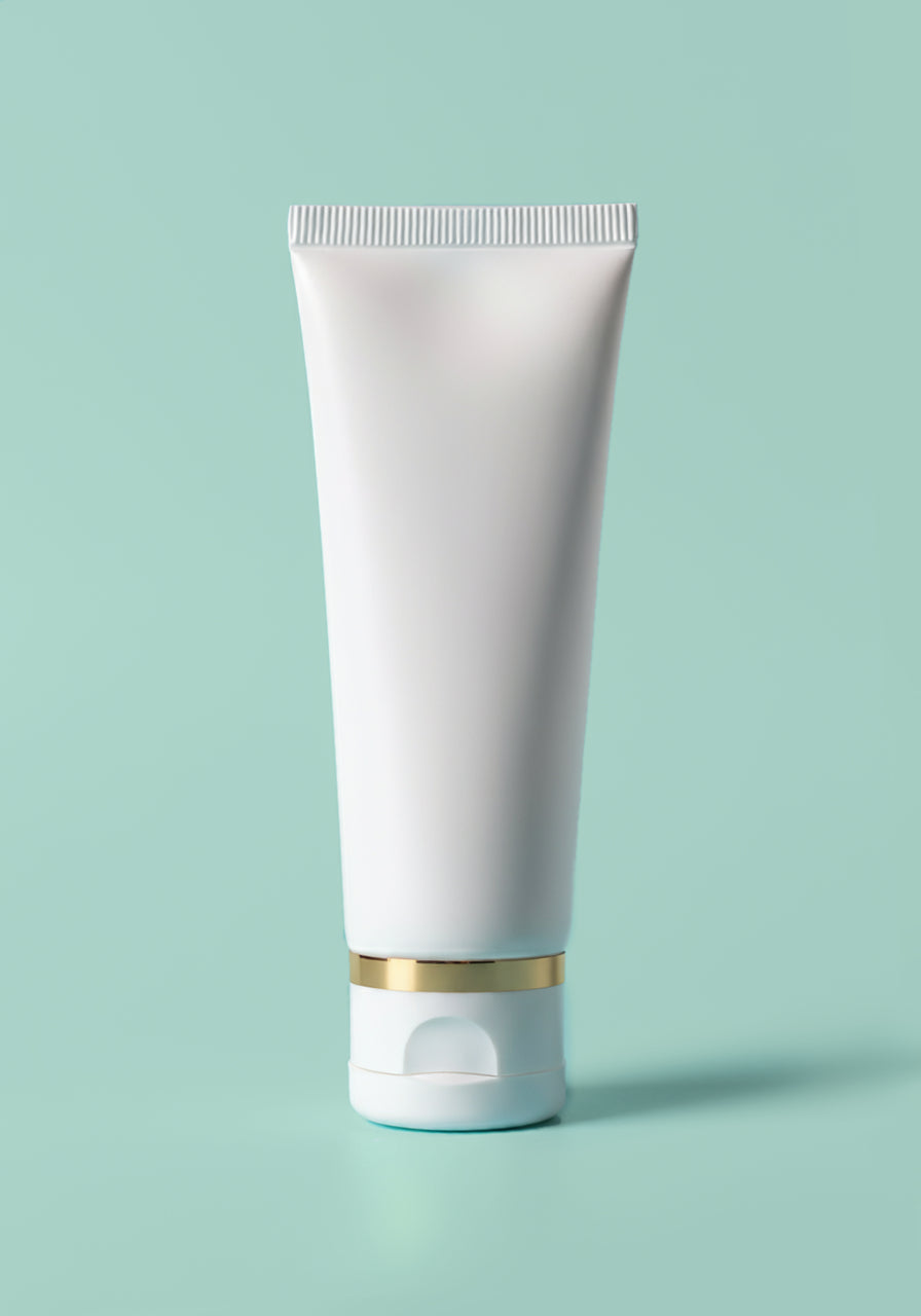 A white tube stored on its cap with a gold accented rim.